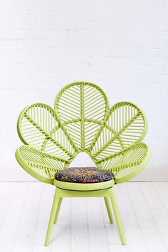 a green chair with a cushion sitting on top of it