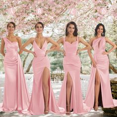 four women in pink dresses standing next to each other with their hands on their hips