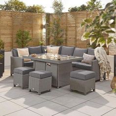 an outdoor dining set with grey cushions