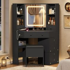 a vanity with lighted mirror and stool in a room