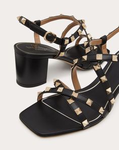 Valentino Garavani Rockstud sandal with straps in calfskin leather - Platinum-finish studs - Adjustable ankle fastening - Leather-covered block heel - Heel height: 60 mm / 2.4 in. - Made in Italy Designer Open Heel Sandals With Studs, Leather Sandals With Studded Block Heels, Leather Sandals With Studded Rubber Outsoles And Block Heel, Leather Sandals With Studs And Open Heel, Studded Leather Sandals With Open Heel, Studded Leather Open Heel Sandals, Designer Ankle Strap Sandals With Studs, Luxury High Heel Sandals With Studs, Formal Sandals With Spikes And Ankle Strap