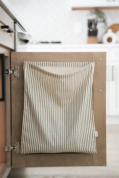 a towel hanging on the side of a cabinet