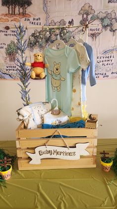 a wooden crate filled with baby items on top of a table