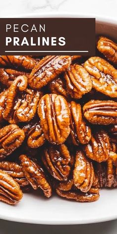 pecan pralies in a white bowl on a marble countertop with the words pecan pralies above it