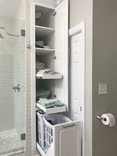 an open door to a bathroom with towels and toiletries in the closet next to it