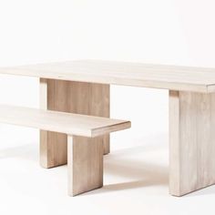 a white table and bench sitting next to each other