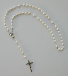 "Italian made rosary for First Communion. LENGTH: 18\" COLOR: White MATERIAL: Moulded Plastic. BEADS: Oval white beads CRUCIFIX: Wood crucifix measures 1-3/8\" x 7/8\" ALL LINKS HAVE BEEN CHECK ONE BY ONE BEFORE SHIPPING THIS ROSARY...HOWEVER IT HAS NOT BEEN DESIGNED TO USE AS A NECKLACE ROSARY AND YOU SHOULD INSTEAD USE CORD ROSARIES FOR THIS PURPOSE. HOWEVER IF YOU DECIDE TO USE IT AS A NECKLACE ROSARY WE WILL NOT BE RESPONSIBLE FOR ANY DAMAGE AND WE DON'T RECOMMEND IT This is a very good qual Make Happy, Plastic Molds, Plastic Beads, First Communion, White Beads, White Material, Rosary, Good Quality, Color White