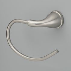 a close up of a metal hook on a wall with a gray back ground background