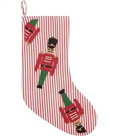 a red and white striped christmas stocking with an image of a nutcracker