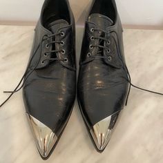 Authentic Miu Miu Black Oxfords Pointed Toe With Asymmetrical Silver Metal Cap Toe Design Vitello Leather With Polished Sheen Lace Up 3/4” Flat Stacked Heel Leather Lining, Sole, Insole Purchased At Neiman Marcus Worn 1x Black Oxfords, Miu Miu Shoes, Toe Designs, Stacked Heel, Flat Shoes Women, Miu Miu, Loafer Flats, Neiman Marcus, Black Silver