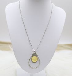 The Silver Beaded Necklace features a delicate strand of silver beads that gracefully supports a vibrant yellow acrylic teardrop pendant. This striking piece combines the shimmer of silver with a bold pop of color, making it a standout accessory that adds a cheerful and chic element to any outfit. Length: 20” Pendant: 1.18” (Width); 1.78” (Length) Closure: Lobster Claw Material: Brass with Silver Plating and Rhodium Coating Lead Free and Hypoallergenic Metal Teardrop Drop Necklace, Silver Teardrop Beaded Jewelry, Teardrop Silver Beads Jewelry Gift, Teardrop Silver Beads Jewelry As Gift, Yellow Beaded Teardrop Jewelry, Yellow Pendant Necklace Nickel Free, Yellow Teardrop Beaded Jewelry, Yellow Pearl Drop Jewelry Gift, Nickel-free Yellow Pendant Necklace