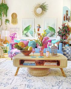 a living room filled with lots of colorful furniture and flowers on top of a coffee table