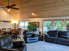 a living room filled with furniture and a ceiling fan