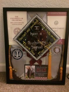 a framed graduation cap and tassels on display