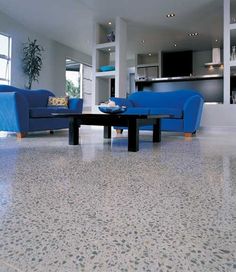 a living room with two blue couches and a coffee table