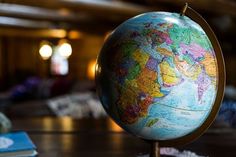 a globe sits on top of a wooden table