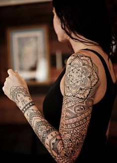 a woman with tattoos on her arm and arms