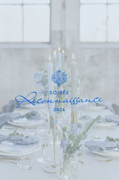 the table is set with white plates and silverware for an elegant dinnereonance