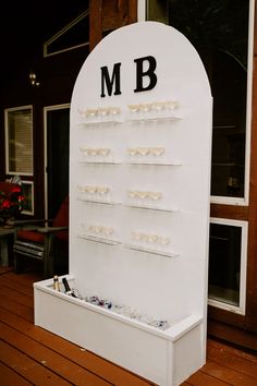 a white display case with glasses on it