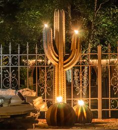 a large cactus sitting on top of a pool next to a fence