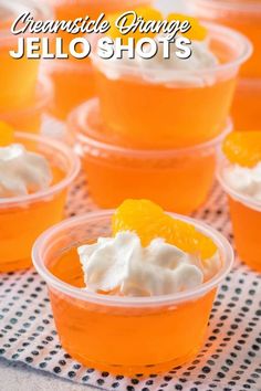 orange jello shots in plastic cups with whipped cream