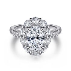 an oval cut diamond engagement ring with halos