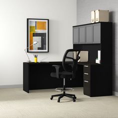 an office chair sits in front of a black desk