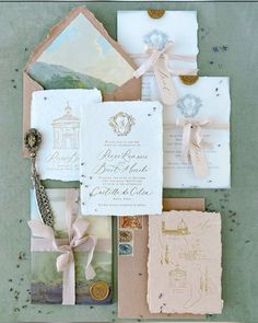 the wedding stationery is laid out on top of each other