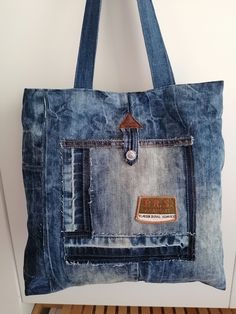 a bag made out of jeans hanging on a wall