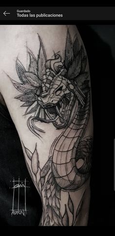 a black and white tattoo with a dragon on it