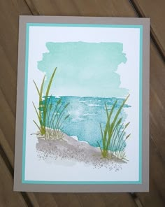 a card with watercolor and grass on the beach