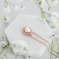 The meaning of "Halo Au Lait" is "Halo with Milk" in French, reflecting the essence of the necklace. The drop-shaped stone is expertly crafted to resemble a drop of milk, capturing the sacrifice of motherhood. Its unique shape also adds deep symbolism to the necklace, reminding us of the life-giving nature of breastmilk. Teardrop Birthstone Necklace For Anniversary, Anniversary Pearl Teardrop Pendant Necklace, White Teardrop Jewelry As A Gift For Her, Anniversary Teardrop Pearl Pendant Necklace, Anniversary Teardrop Gemstone Drop Necklace, Delicate White Pear-shaped Necklace, Pear-shaped Pearl Pendant Necklace As Gift, Rose Gold Teardrop Necklace With Pearl Pendant, Pearl Drop Oval Pendant Necklace For Gift