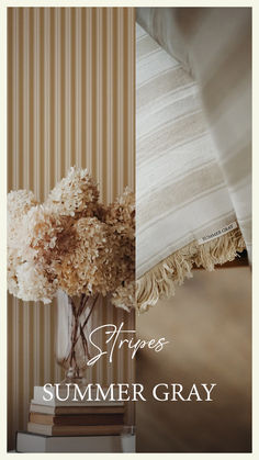 a vase filled with flowers sitting on top of a table next to a striped wall