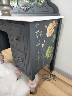 an antique vanity with painted flowers on it