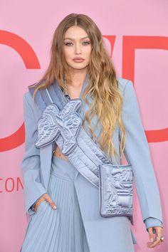 a woman with long hair wearing a blue outfit