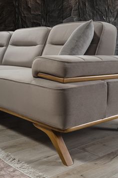 a gray couch sitting on top of a wooden floor