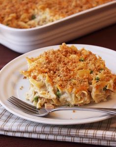 a white plate topped with lasagna next to a casserole dish