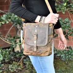 This genuine leather bag in rustic brown leather features a removable crossbody strap, and matches everything! Top zipper closure, with a button snap fold over flap. Back has a zipper pocket as well. 10"Wx10"Hx2.5"D strap: 112-24" Brown Satchel With Brass Hardware For Everyday Use, Vintage Brown Shoulder Bag With Brass Hardware, Vintage Brown Shoulder Bag With Brass Hardware For Everyday, Everyday Distressed Brown Leather-lined Shoulder Bag, Brown Leather Satchel With Snap Closure, Fall Bags With Brass Hardware, Rugged Crossbody Bag For Everyday Use, Everyday Bags With Brass Hardware For Fall, Rugged Satchel With Adjustable Strap For Everyday Use