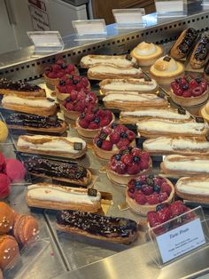 a display case filled with lots of different types of pastries and desserts on top of each other