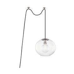 a glass ball hanging from a black cord on a white wall with a light bulb attached to it