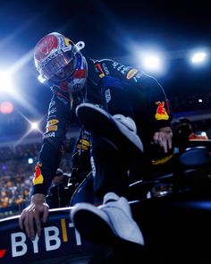 a man sitting on top of a race car