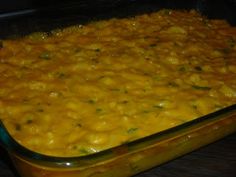 a casserole dish with cheese and green onions in the oven, ready to be eaten