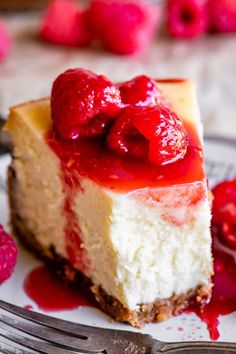 a piece of cheesecake with raspberries on top