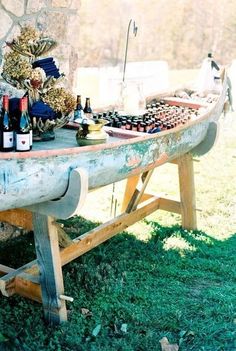 a picnic table with wine bottles and snacks on it