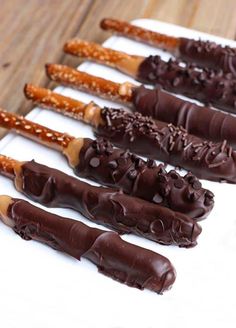 chocolate covered pretzels are lined up on a white plate