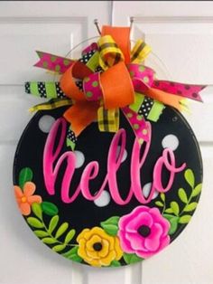 a door hanger with the word hello painted on it