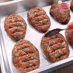 six hamburger patties sitting on top of a metal pan