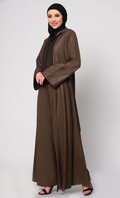 Elevate your modest fashion with our Hoodie Abaya, where contemporary style meets traditional elegance. Crafted from high-quality fabric, this abaya features intricate check embroidery, adding a touch of sophistication. The front is adorned with charming tassels that sway gracefully with your movements, creating a dynamic silhouette. Designed for both comfort and style, it includes two practical pockets, perfect for keeping essentials close at hand. Whether worn casually or for special occasions, this Hoodie Abaya promises to be a versatile and timeless addition to your wardrobe. Size & FitModel height is 5’9’’ and is wearing a Small size Material & CareMaterial: Slub PoplinCare: Gentle machine wash in cold water or Drycleaning SpecificationsSleeve Length: Full SleevesLength: Ankle Length Hoodie Abaya, Check Embroidery, Abaya With Pockets, Brown Hoodie, Ankle Length, Black Hoodie, Modest Fashion, Contemporary Style, Quality Fabric