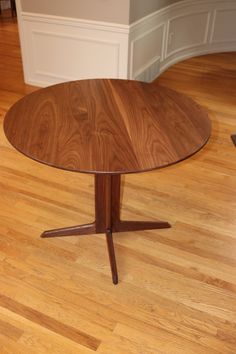 a wooden table sitting on top of a hard wood floor