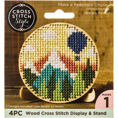 the cross stitch kit has been designed to look like it is made with wood and fabric